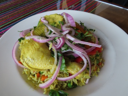 Arroz Con Pollo - Rice fried with Aji Amarillo sauce and cilantro. Mixed with Green Peas and Red Peppers and topped with Chicken.
