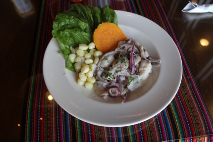 Ceviche - Another Peruvian favorite, fresh raw fish cured in the citrus acids of fresh limes and garnished with onions, lettuce, peppers and spices. Served with Peruvian Corn and Sweet Potatos. Served with Peruvian Corn and Sweet Potatoes.