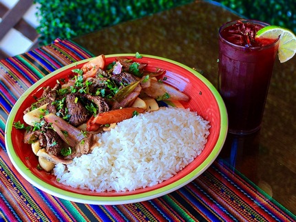 Lomo Saltada - Traditional Peruvian stir fry with strips of marinated steak cooked with onions and tomatoes in a soy sauce combined with Aji Amarillo. Served with White Rice and French Fries.