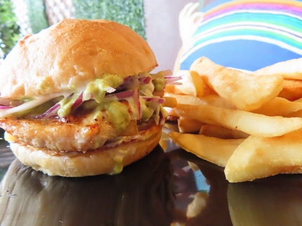 Pan con Pollo - Grilled chicken smothered in the unique blended tastes of the Salsa Criolla, garlic mayonnaise and aji verde. Squeezed together with fries into a locally baked bun. Served with Fries.