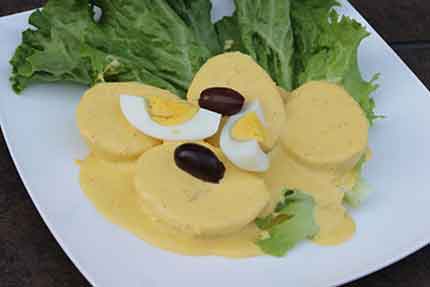 Papa a la Huancaína - Your choice of boiled yellow potatoes or yuca in a cheesy Huancaína sauce. Although the dish's name is derived from <a class='menu-link' href='https://en.wikipedia.org/wiki/Huancayo' target='_blank'>Huancayoa</a>, city in the Peruvian highlands, this dish is from <a class='menu-link' href='https://www.peru.travel/en-us/where-to-go/lima.aspx' target='_blank'>Lima - Perú</a>. It has become a staple of everyday and holiday cuisine throughout the country.