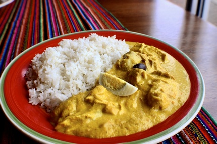 Aji de Gallina - A delicious Peruvian classic, shredded chicken in a yellow cream sauce made from walnuts and Amarillo peppers. Served with White Rice.