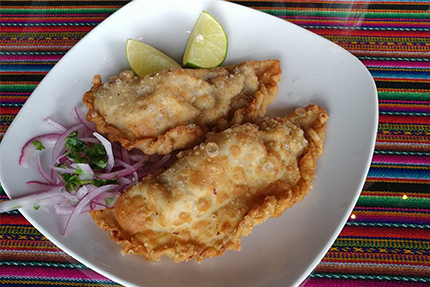 Empanada - Two turnovers filled with beef, olives, eggs and Peruvian spices. A Peruvian twist to the famous South American finger food.